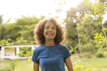 portrait of an older woman outside his house on the warm center equator