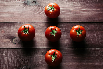 Freshly picked ripe tomatoes on a wooden retro table. Preparations for cooking. Close up. Modern style