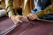 © ALTO IMAGES/Stocksy - Worker Cutting Fabric With Scissors In Sofa Workshop