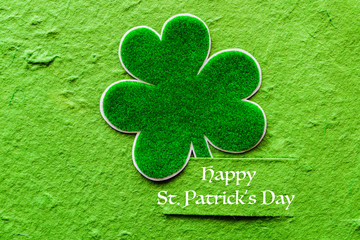 Wall Mural - Happy St Patricks Day message on green paper clover and bright green Mulberry paper background