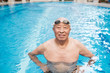 © aremafoto/Stocksy - Senior Asian Man Standing in the Swimming Pool