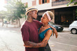 © Lucas Ottone/Stocksy - Young multiracial couple hugging in the street