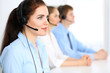 © rogerphoto - Call center operators. Focus at  business woman in headset