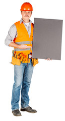 Wall Mural - male builder or manual worker in helmet with white blank banner over white wall background.