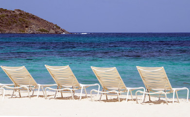 Island living on beach with colorful water 