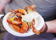 © isavira - Boiled crab on a plastic plate in a hand