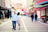 Fototapeta Miasto - Happy couple walking with balloons in central street of Tirana, Albania, at the New Bazaar, or Pazari i ri
