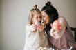 © MeganBetteridge - Mother and Daughter Painting Easter Eggs together