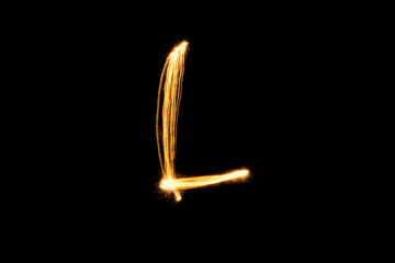 Light painting alphabet L on black back ground isolate.