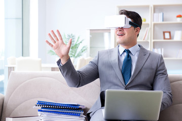 Businessman with virtual reality glasses in modern technology co