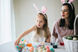 © MeganBetteridge - Mother and Daughter Painting Easter Eggs together
