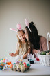 © MeganBetteridge - Mother and Daughter Painting Easter Eggs together