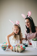 © MeganBetteridge - Mother and Daughter Painting Easter Eggs together