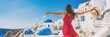 canvas print picture - Europe travel vacation fun summer woman feeling free dancing with arms open in freedom at Oia, Santorini, Greece island. Carefree girl tourist banner panorama.