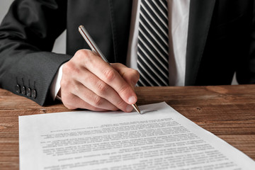 Wall Mural - businessman signing a document.