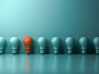 Poster - think different concept , one orange light bulb standing out from the green incandescent lightbulbs 
