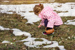 © Lucky Fenix - little girl picking snowdrop flowers in spring .