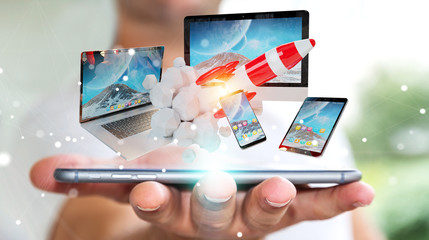 Wall Mural - Businessman connecting tech devices and startup rocket 3D rendering