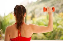 Young Athletic Woman Exercising On Verandah: Overhead Press For Upper Body Strength