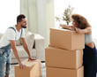 © ASDF - Happy and young couple looking at boxes