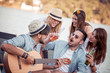 © ivanko80 - Group of friends enjoying party on the beach