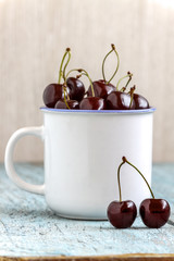 Wall Mural - Cherries in the beautiful cup on wooden table, macro background, fruits, berries