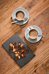 two espresso coffee with dark chocolate on wooden table