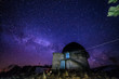 Night view of astronomical observatory against background of starry sky with milky way
