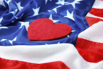 Wall Mural - Red felt heart on American flag. USA holiday