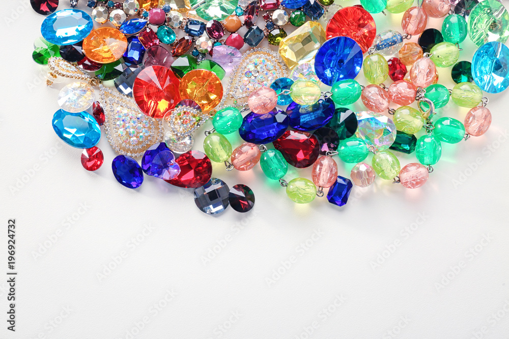 Jewellery with colorful precious stones on white background