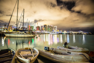 Beautiful view of San Diego California at night after sunset with boats and lights of skyline in the background