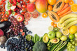 Healthy eating, varieity of fruits and vegetables in rainbow colours on the off white table arranged in a frame with copy space, vertical top view, selective focus