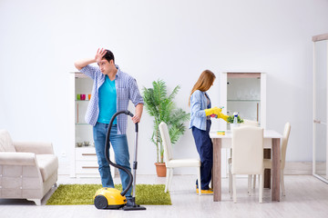 Young family cleaning the house