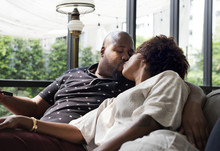 Black Couple Kissing On The Couch