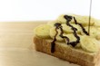The chocolate dip is a fresh on bnanas and bread slice in the morning,placed on the wooden board is ready to eat.
