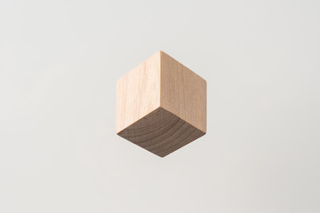 Design concept - abstract geometric real wooden cube with surreal layout on grey background , it's illusion like  hexagon, and it's not 3D render