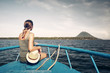 © soft_light - Traveler woman sit on boat looking to a island Bunaken and volcano Manado Tua. North Sulawesi, Indonesia.
