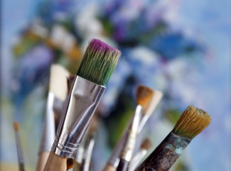 Artistic brushes on the background of a painting with a paint