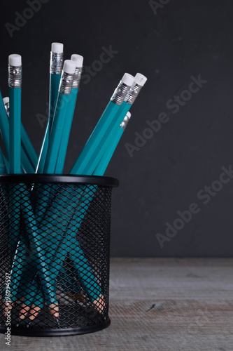 Fotografie, Obraz Pencils in metal holder pot in front of wall background