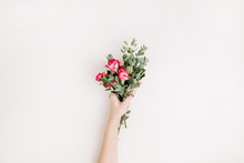 Woman Hand Hold Rose Flowers And Eucalyptus Bouquet On White Background. Flat Lay, Top View Spring Blog Hero Header Background.