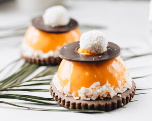 Delicious two cakes on white table with leaves, sweet dessert