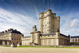 Chateau de Vincennes in Paris. France castle with French national flag under the sunny blue sky.