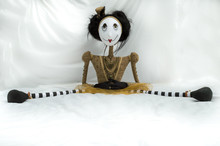 Creepy Steampunk Rag Doll Sitting With Legs Wide Apart. Facing Forward. Lifesize Doll On A Grungy White Background. Part Of A Series Of Different Poses. Copy Space.