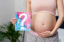 Cropped Shot Of Pregnant Woman Holding Card With Question Mark