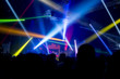 © Photo Market - Crowd at concert - Cheering crowd in front of bright colorful stage lights.Defocused image.