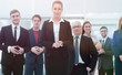 © ASDF - confident business woman standing in front of his business team.