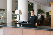 Pretty Hotel Worker Working In Reception