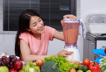 Sticker - woman making smoothies with blender in kitchen