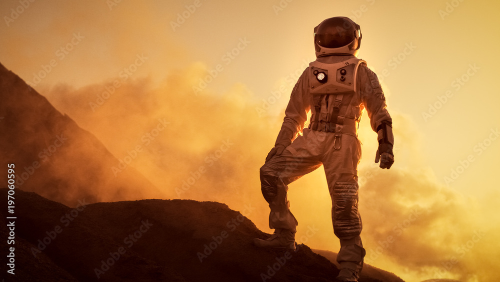 Silhouette of the Astronaut Standing on the Rocky Mountain of the Alien Red Planet/ Mars. First Manned Mission on Mars. Space Exploration, Colonization. - obrazy, fototapety, plakaty 