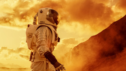 Wall Mural - proud astronaut confidently walks on mars surface. red planet covered in gas and rock, overcoming di